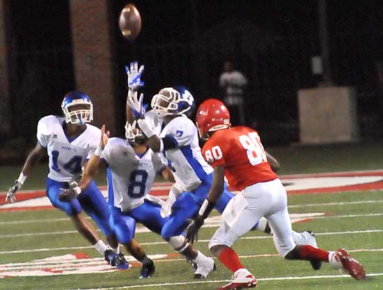 Bryant's Aaron Bell goes up for the ball after Fort Smith Northside's Ernest Gray (80) lost it as Chris Stephens (14) and Caleb Thomas (8) converge on the play. (Photo by Kevin Nagle)