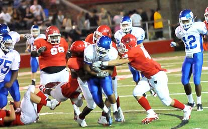 Karon Dismuke powers through tacklers. (Photo by Kevin Nagle)