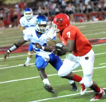 Walter Dunn (34) closes in on Northside's quarterback Kenrick Burns (7). (Photo by Kevin Nagle)