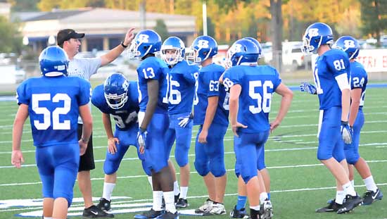 Coach Jason Hay meets with a group of the JV players during a break in Monday's action. (Photo by Kevin Nagle)