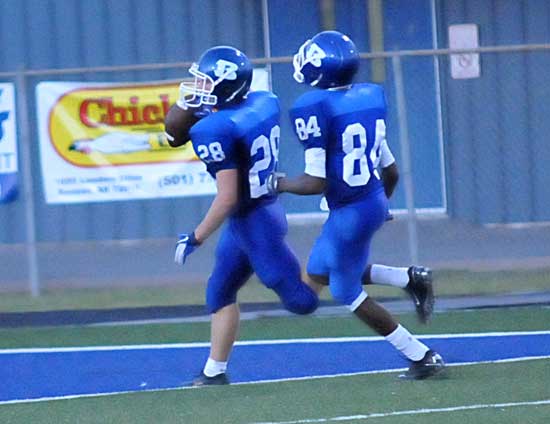 Davis Nossaman (28) crosses the goal line after his 71-yard return of an interception with teammate Darrien Jarrett providing an escort. (Photo by Kevin Nagle)