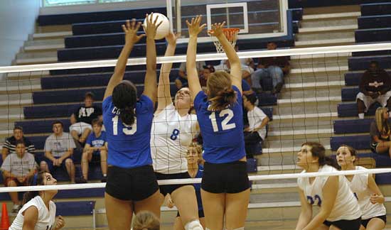 Erica Smith tries to get a hit over a pair of Conway players. (Photo by Kevin Nagle)