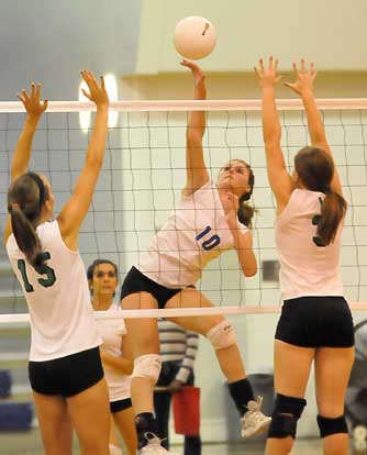 Bryant's Alyssa Anderson (10) sends a spike over the Van Buren defense. (Photo by Kevin Nagle)