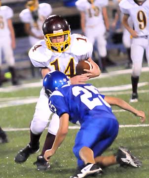 Houston Chavis (25) hits the Lake Hamilton quarterback. (Photo by Kevin Nagle)