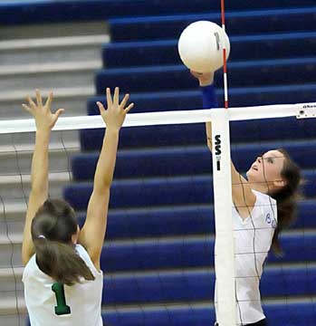 Kaylon Wilson, right, spikes the ball over a Van Buren blocker. (Photo by Kevin Nagle)