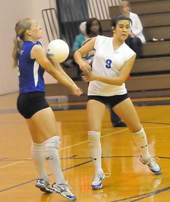 Bryant libero Lauren Reed, left, and Rochelle Aguilar (9). (Photo by Kevin Nagle)