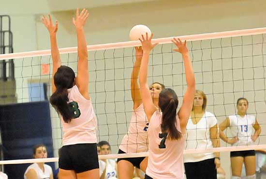 Bryant's Peyton Thacker (2) attempts to get a hit over or through a pair of Van Buren blockers. (Photo by Kevin Nagle)