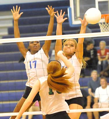 Brianna White and Hannah Rice reach for a block. (Photo by Kevin Nagle)