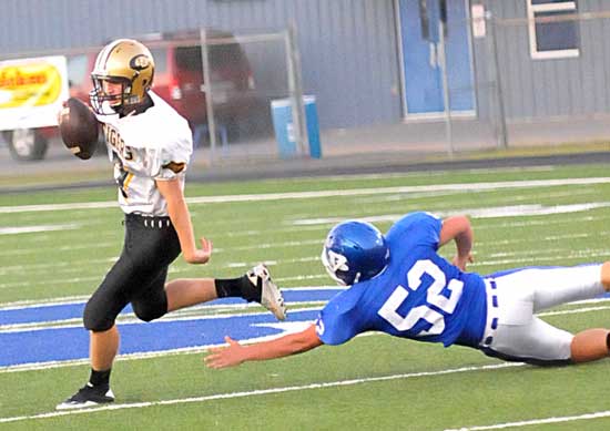 Bryant's Colton Caviness (52) dives to try to tackle a Central ball carrier. (Photo by Kevin Nagle)