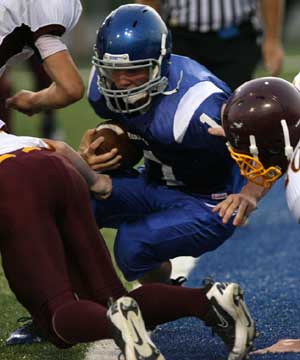 Ty Harris squeezes into the end zone for a two-point conversion. (Photo by Rick Nation)