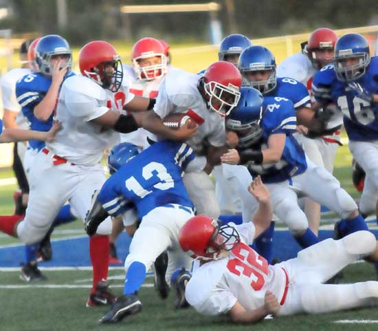 Gunnar Burks (13) and Devin Howard (44) lead the Bryant Blue defensive charge. (Photo by Kevin Nagle)