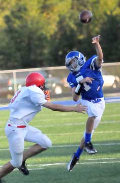 Evan Lee (7) launches a pass under pressure from Cabot South's Eric Pigue. (Photo by Kevin Nagle)