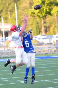 Bryant's Liam Miller (5) and a Cabot South defender vie for pass. (Photo by Kevin Nagle)