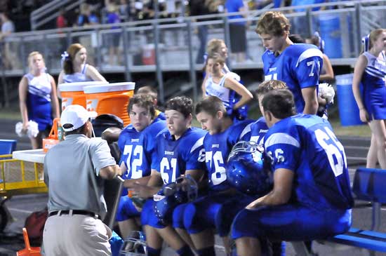 Offensive line coach Kirk Bock talks with Andrew McBride (72), Tanner Neal (61), Zack McConnell (76), Caleb Chaffin (66) and Jimbo Seale (71). (Photo by Kevin Nagle)