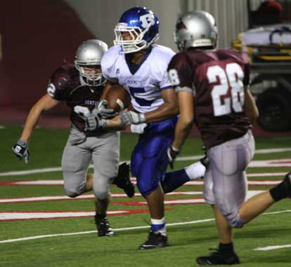 Karon Dismuke scores the clinching touchdown between Benton's Collin Simmons and Brant Stout. (Photo by Rick Nation)