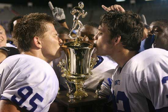 Michael Smith and Parker Dunn give the Salt Bowl trophy some love. (Photo by Rick Nation)