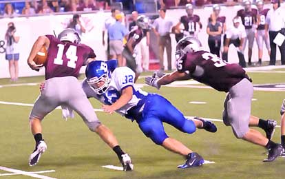 Parker Dunn (32) tracks down Benton quarterback Dylan Harris (14) before Trevor Nix can get there to block. (Photo by Kevin Nagle)