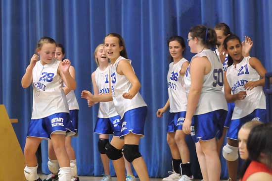 The Bryant White seventh grade girls volleyball team celebrates its win on Tuesday. (photo by Kevin Nagle)