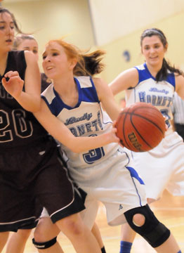 Bryant's Nikki Clay tries to get to the basket as Benton's Savanah Mayo defends. (Photo by Kevin Nagle)