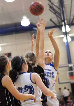 Katie Davidson launches a shot under duress in front of teammate Mallory Curry (22). (Photo by Kevin Nagle)