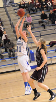 Bryant's Taylor Lindberg goes up for a shot in front of Benton's Ashley Dintleman. (Photo by Kevin Nagle)