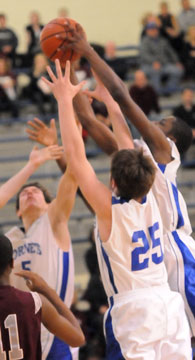 Brandan Warner (5), Ryan Hall (25) and J.C. Newborn contend for a rebound. (Photo by Kevin Nagle)
