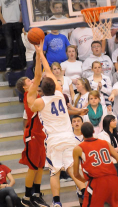 Bryant's Zach Cambron (44) rejects a shot by Russellville's Jordan Barrett. (Photo by Kevin Nagle)