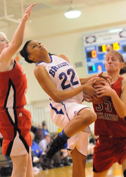 Bryant's Kiara Moore (22) has the ball tied up by Russellville's Mary Carol Davis. (Photo by Kevin Nagle)
