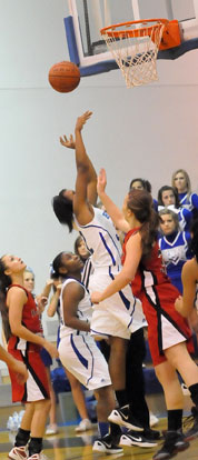 Taneasha Rhode goes up for a shot in front of teammate Dezerea Duckworth and Russellville defender Lindsey Glover. (Photo by Kevin Nagle)