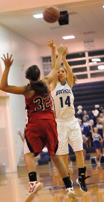 Peyton Weaver (14) tries to shoot over Russellville's Kaylee Weidower. (Photo by Kevin Nagle)