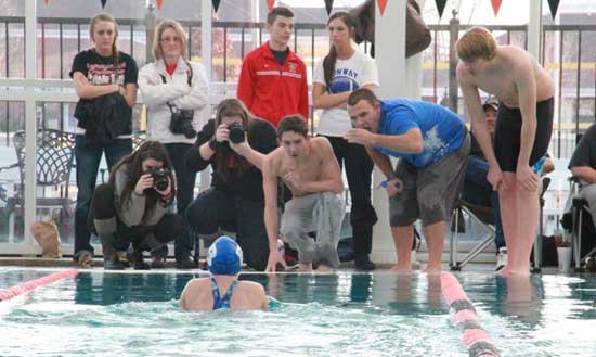 Morganne Gillespie is urged on to the finish line by her Bryant teammates. (Photo by DeDe Gillespie)