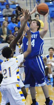 Zach Cambron (44) shoots over a pair of North Little Rock defenders. (Photo by Kevin Nagle)