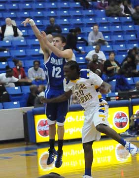 Bryant's Brantley Cozart fires a shot over North Little Rock's DayShawn Watkins (20). (Photo by Kevin Nagle)