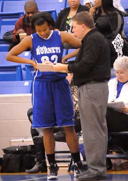 Bryant head coach Brad Matthews instructs sophomore Taneasha Rhode. (Photo by Kevin Nagle)