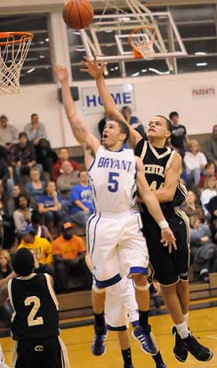 Bryant's Jordan Griffin (5) gets a shot away in front of Central's Marcus Dortch. (Photo by Kevin Nagle)