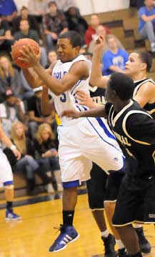 C.J. Rainey (3) pulls down a rebound. (Photo by Kevin Nagle)