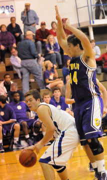 Zach Cambron, left, starts a move to the basket against Catholic's Matt Morris. (Photo by Kevin Nagle)