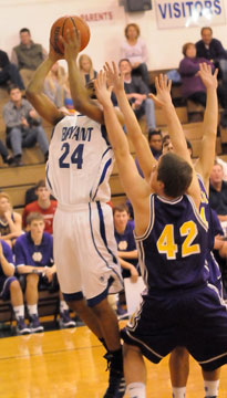 Jalen Hewett (24) takes a shot over a pair of Rockets defenders. (Photo by Kevin Nagle)