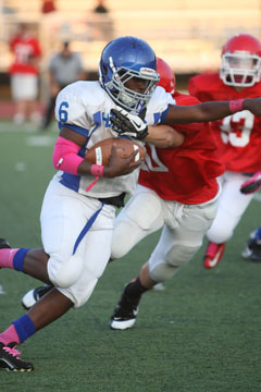 Philip Isom-Green (6) tries to shake a Cabot North tackler. (Photo by Rick Nation)