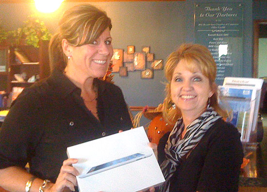 Julie Barrow receiving the ipad from Dianna Fulmer of the Bryant Area Chamber of Commerce