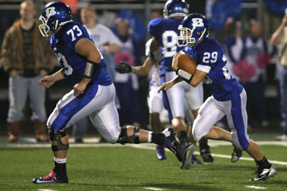 Blake Hobby (73) leads Hunter Lawhon (29) downfield. (Photo by Rick Nation)