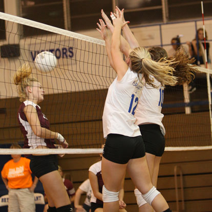 McKenzie Rice (12) and Alyssa Anderson (10) combine on a block. (Photo by Rick Nation)