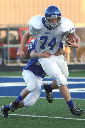 Bryant Blue's Collin Welch (15) brings down Bryant White punter Chase Fox after a bad snap on a play that set up Blue's touchdown. (Photo by Rick Nation)