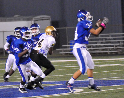 Devon Alpe (34) makes an interception as Kris Croom (26) looks for someone to block. (Photo by Kevin Nagle)