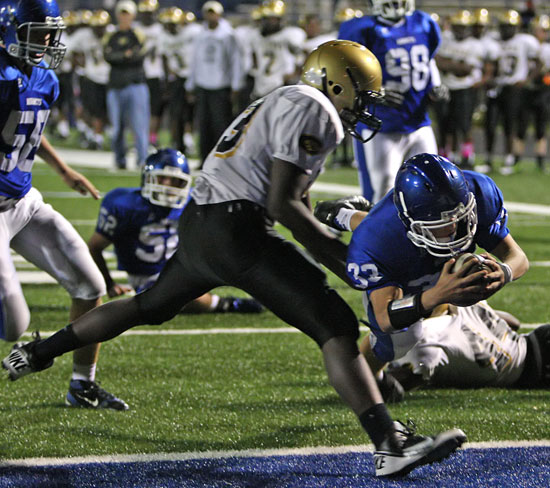 Drew Alpe dives into the end zone after getting blocks from Jake Hall (58), Peyton Robertson (52) and Cameron Murray (98). (Photo by Rick Nation)