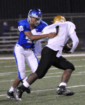 Kameron Guillory (40) endures a face mask as he tries to bring down Central's Terray Truitt. (Photo by Kevin Nagle)