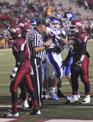 Hayden Lessenberry shows the football after scoring on of his two rushing touchdowns Friday night. (Photo by Kevin Nagle)