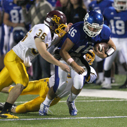 Bryant quarterback Hayden Lessenberry strains for extra yardage as Lake Hamilton's Joey Wilderson (36) arrives to help his teammate. (Photo by Rick Nation)