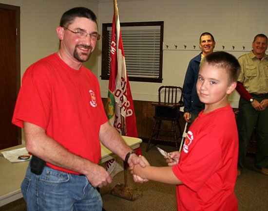 Colton Ellis receives his Scout badge.