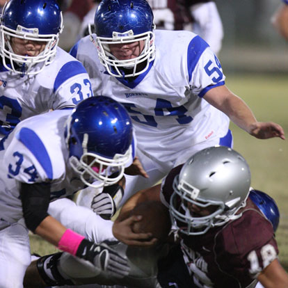 Devon Alpe (34) makes a tackle on Benton's Casen Maertens as twin brother Drew Alpe (33) and teammate Walker Brown (54) arrive to help. (Photo by Rick Nation)